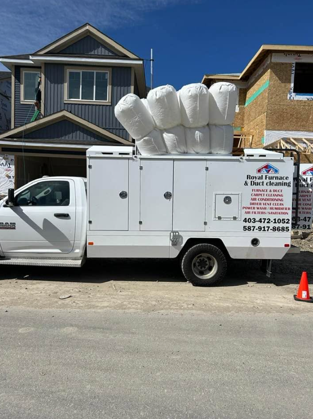 Royal Furnace and Duct Cleaning branded truck parked at a Calgary home with its rooftop collection bags visible